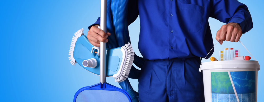 horizontal image of man holding pool cleaning equipment
