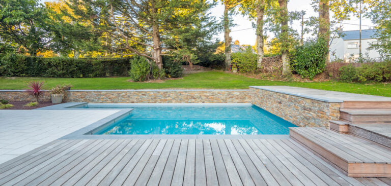 An image that captures a serene backyard setting featuring a maintained swimming pool